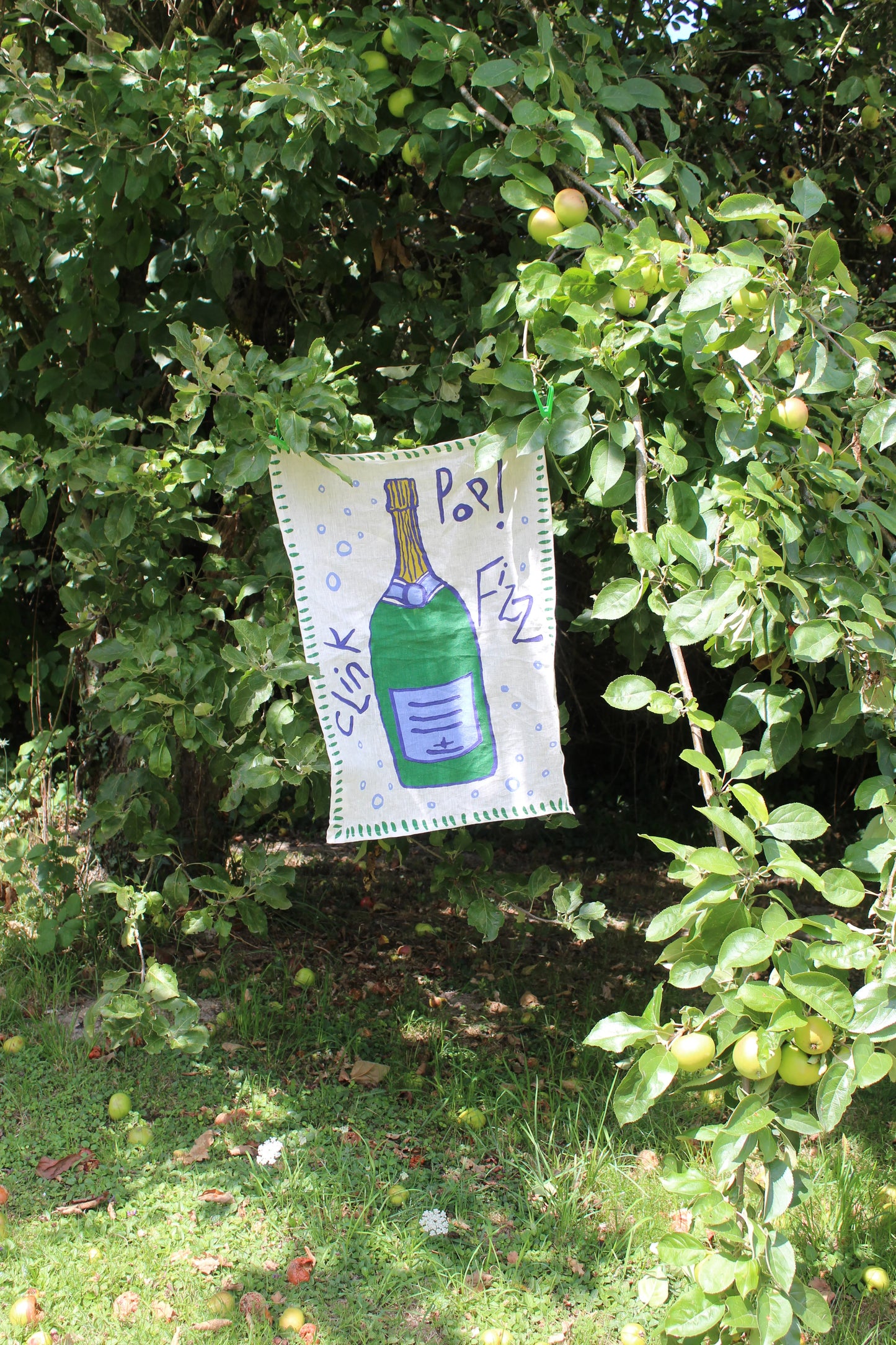 100% sustainable Flax Linen tea towel Hand-crafted unique design printed with eco-friendly dyes from Amuse la Bouche.  champagne bottle with 'Pop! Fizz!' 