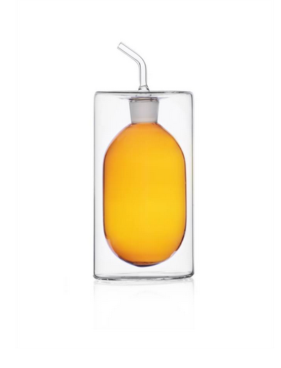 Stylish 2 walled glass oil bottle. Clear glass with amber interior 250 ml capacity. Hand made and flame worked.
Uses : Oil,Vinegar, Syrup dispenser
Kitchen to table